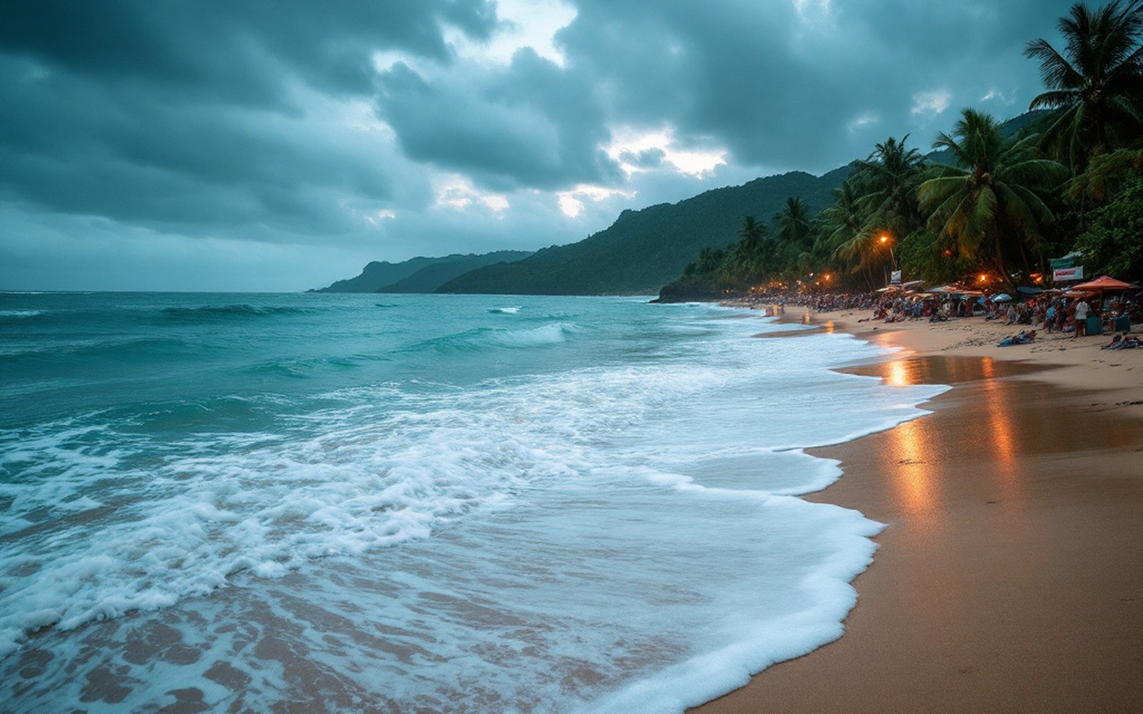 Open ocean filling most of the frame under a bruised monsoon sky, breaking surf on bare sand in the foreground, no bridge, no river, no boat and no building anywhere in shot